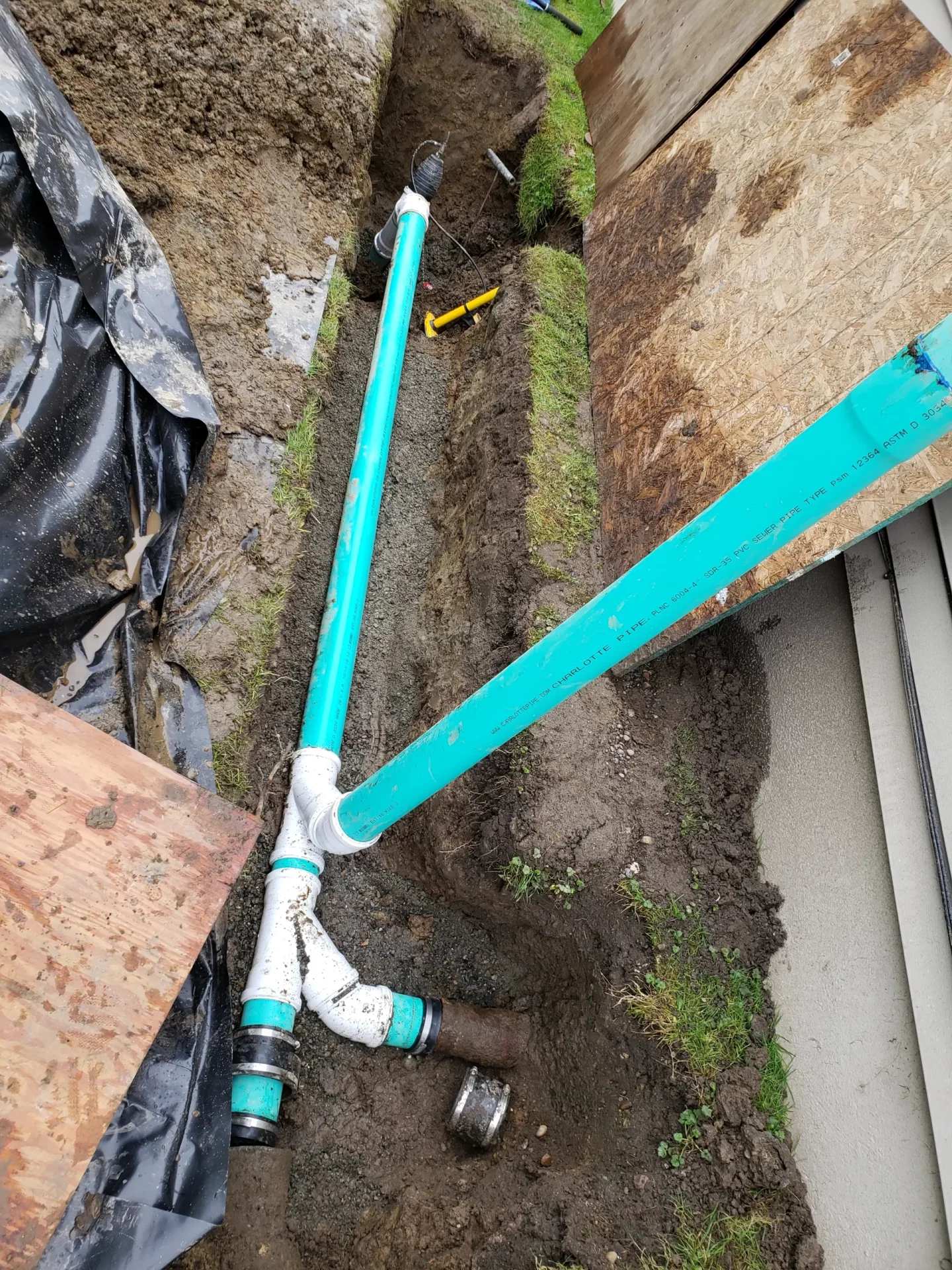 Water service pipe and fittings in a trench.