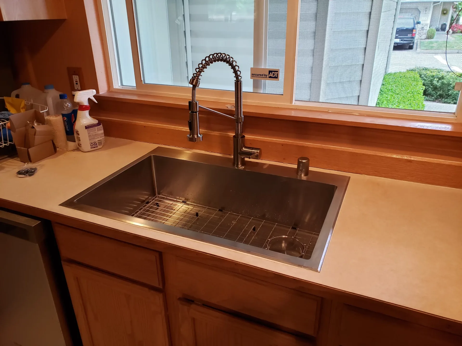 Kitchen sink and faucet beside a window.
