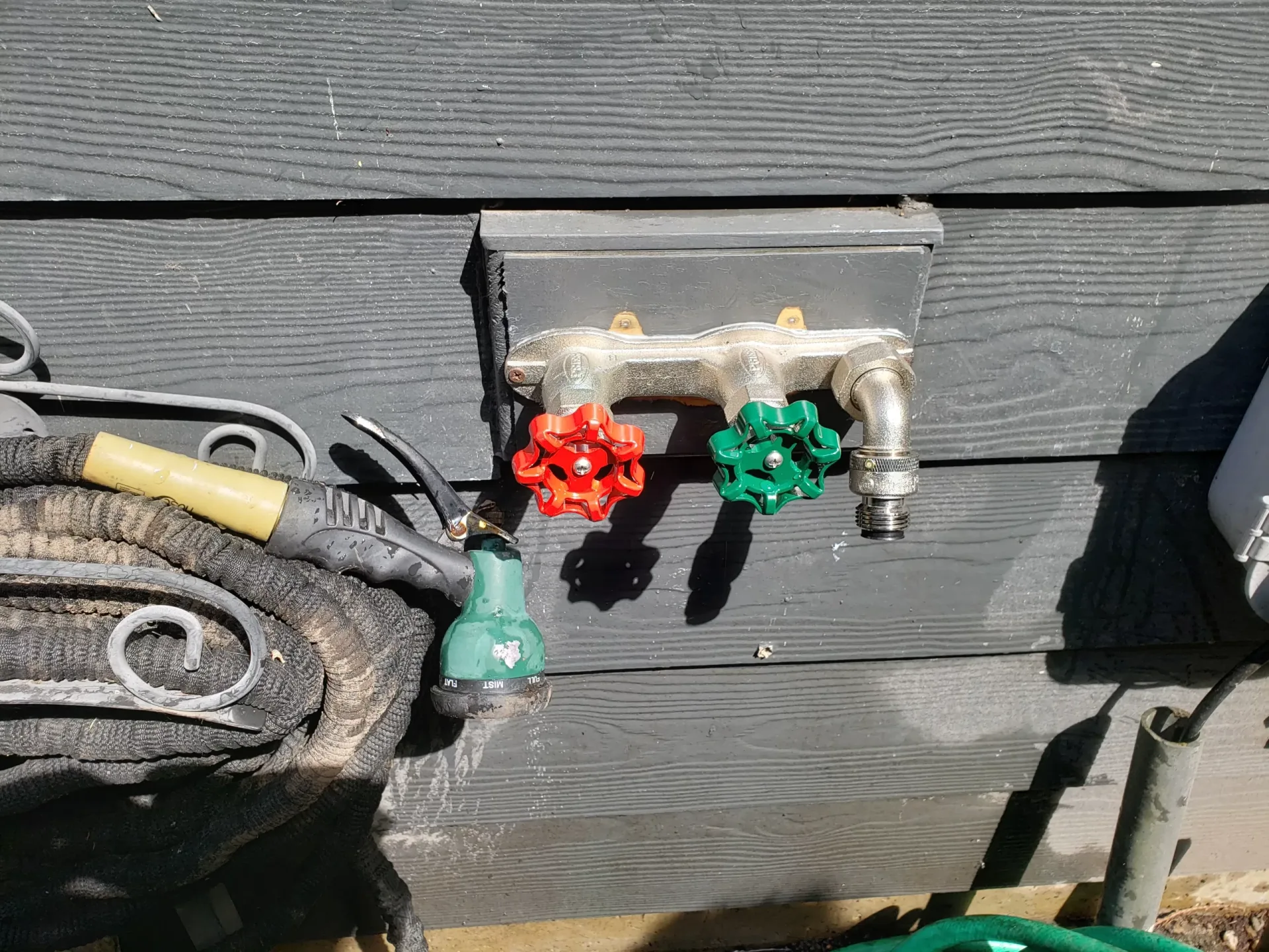 Outdoor water shutoff valves and pipe connections.