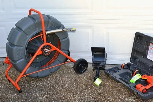 Drain cleaning equipment with a large reel and inspection camera.